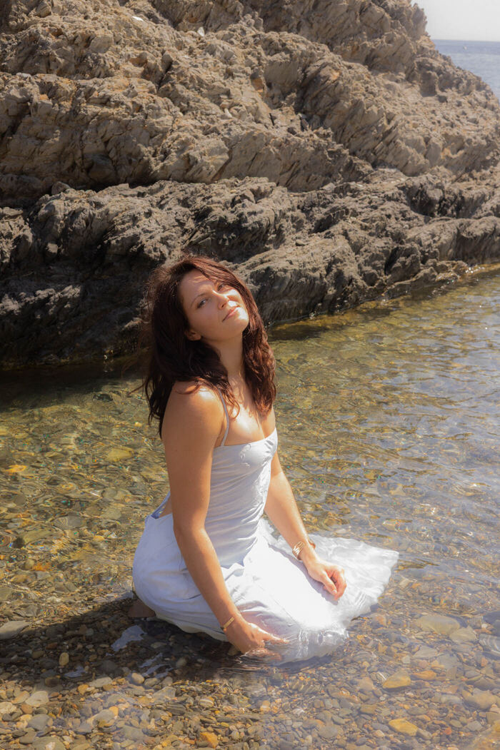 Portrait éditorial en bord de mer, robe blanche